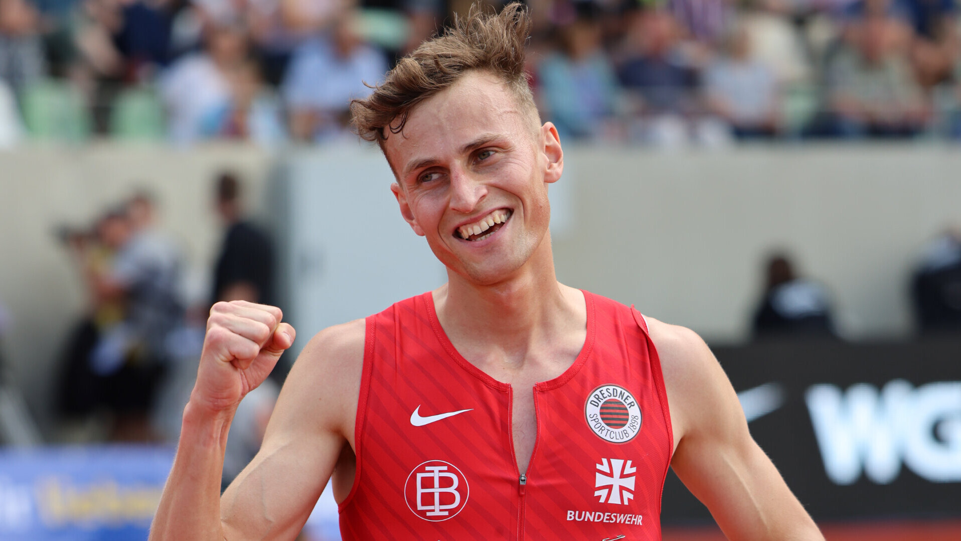 Porträt von Hindernisläufer Karl Bebendorf im DSC-Trikot, der die Faust ballt