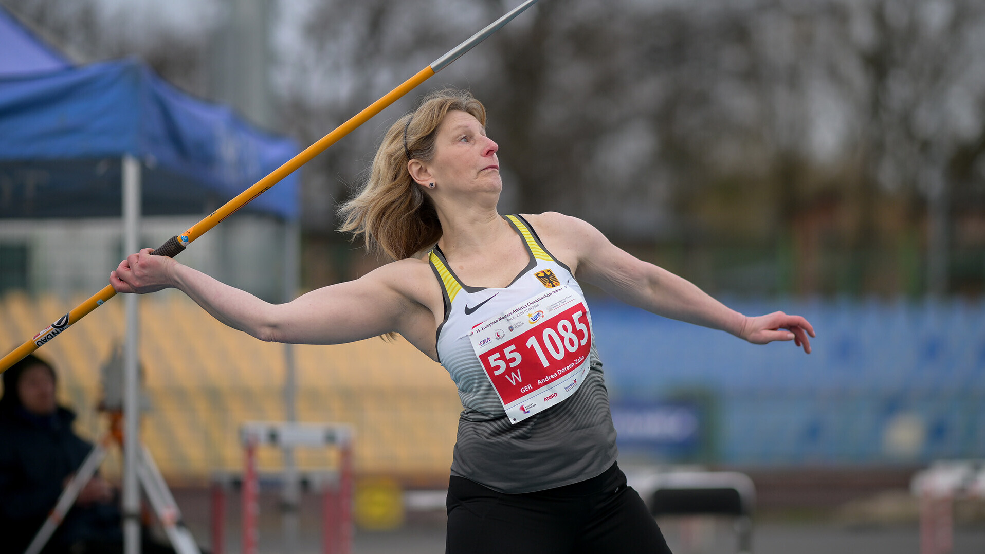 Andrea Zahn mit gestrecktem Arm und Speer in der Hand