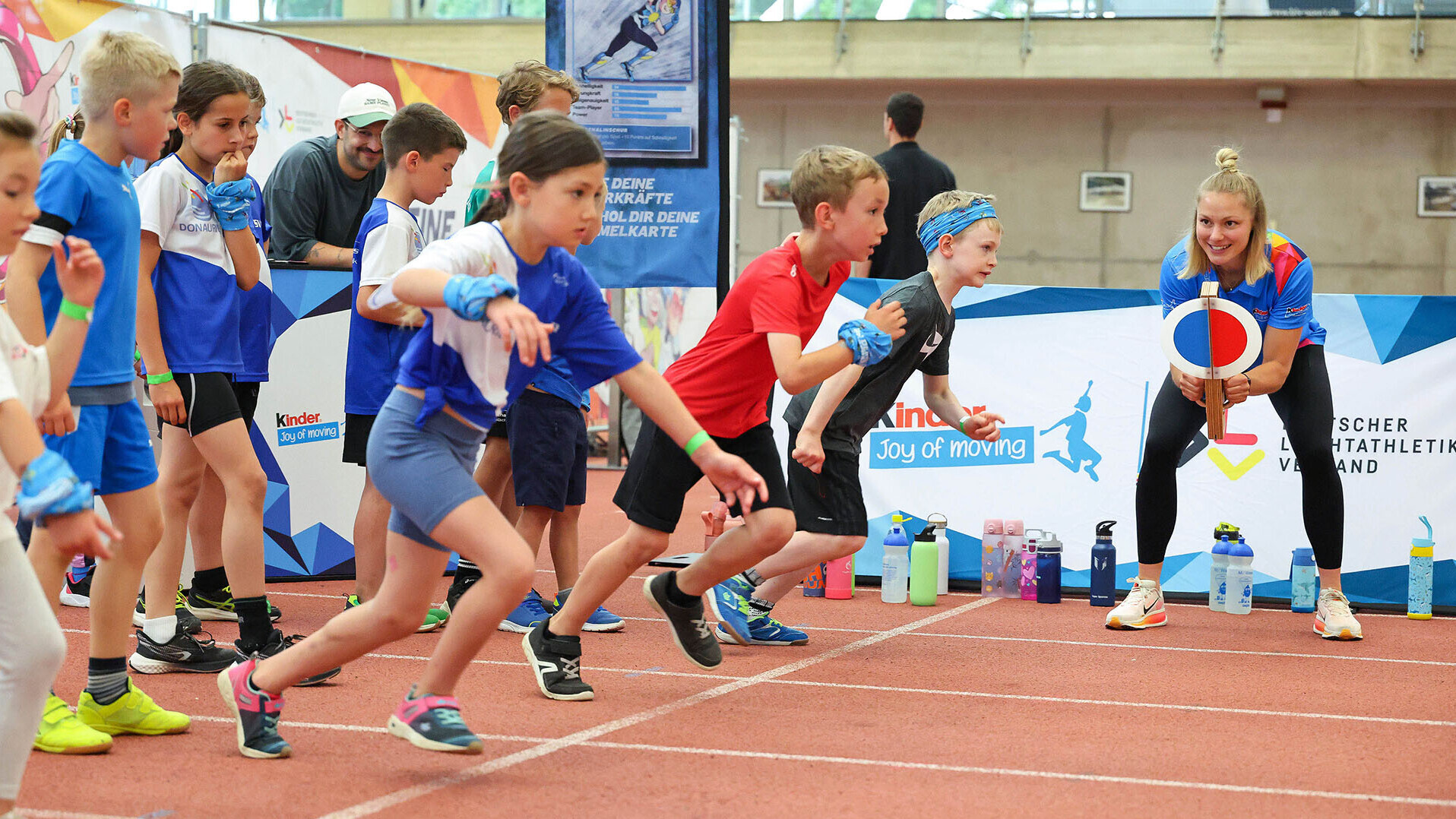 Sprinterin Lisa Mayer gibt beim Spotlight-Event in München den Startschuss, die Kinder sprinten los. 