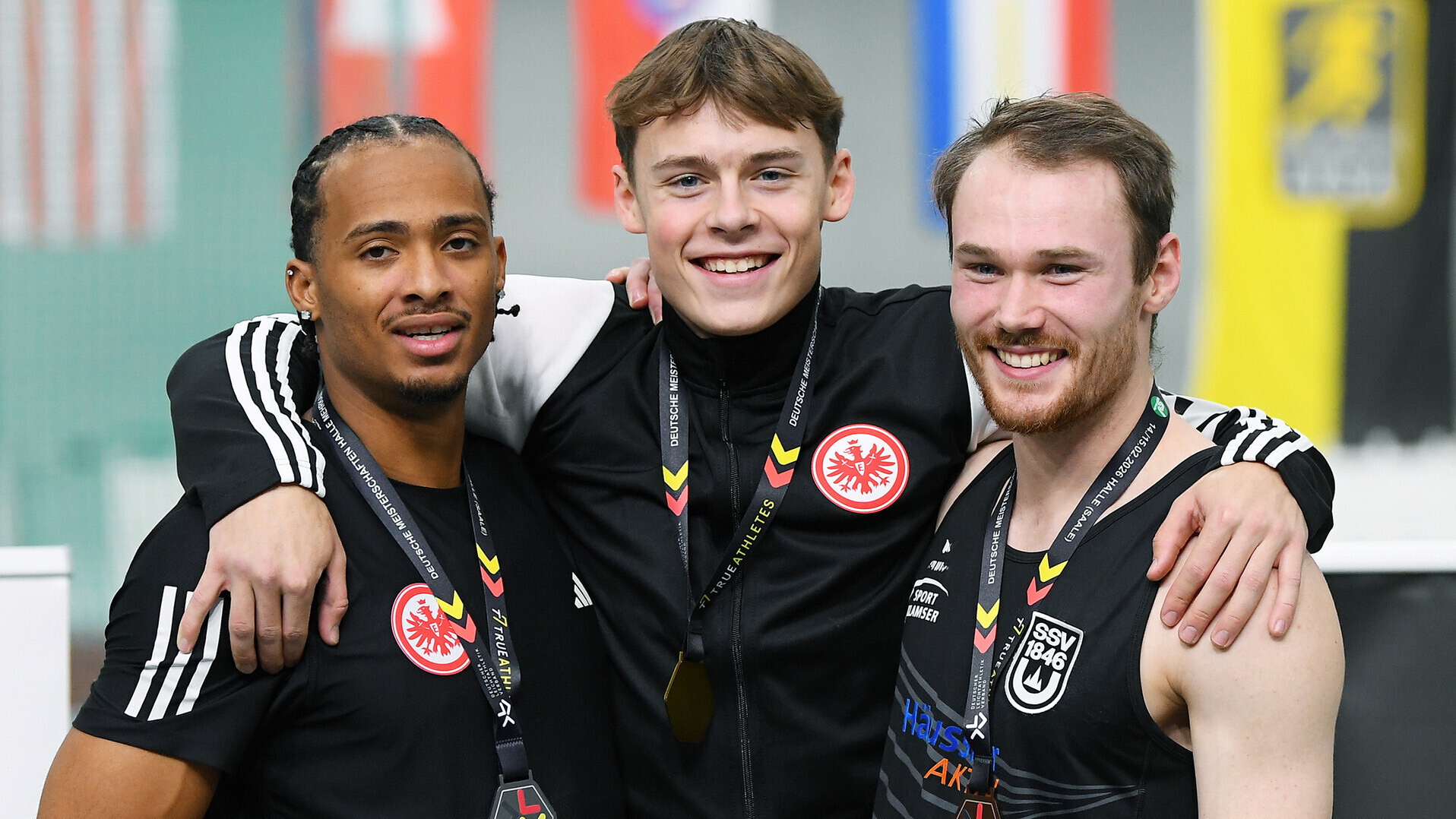 Fred Isaac Fleurisson, Amadeus Gräber und Roman Jocher Arm in Arm mit Medaillen um den Hals