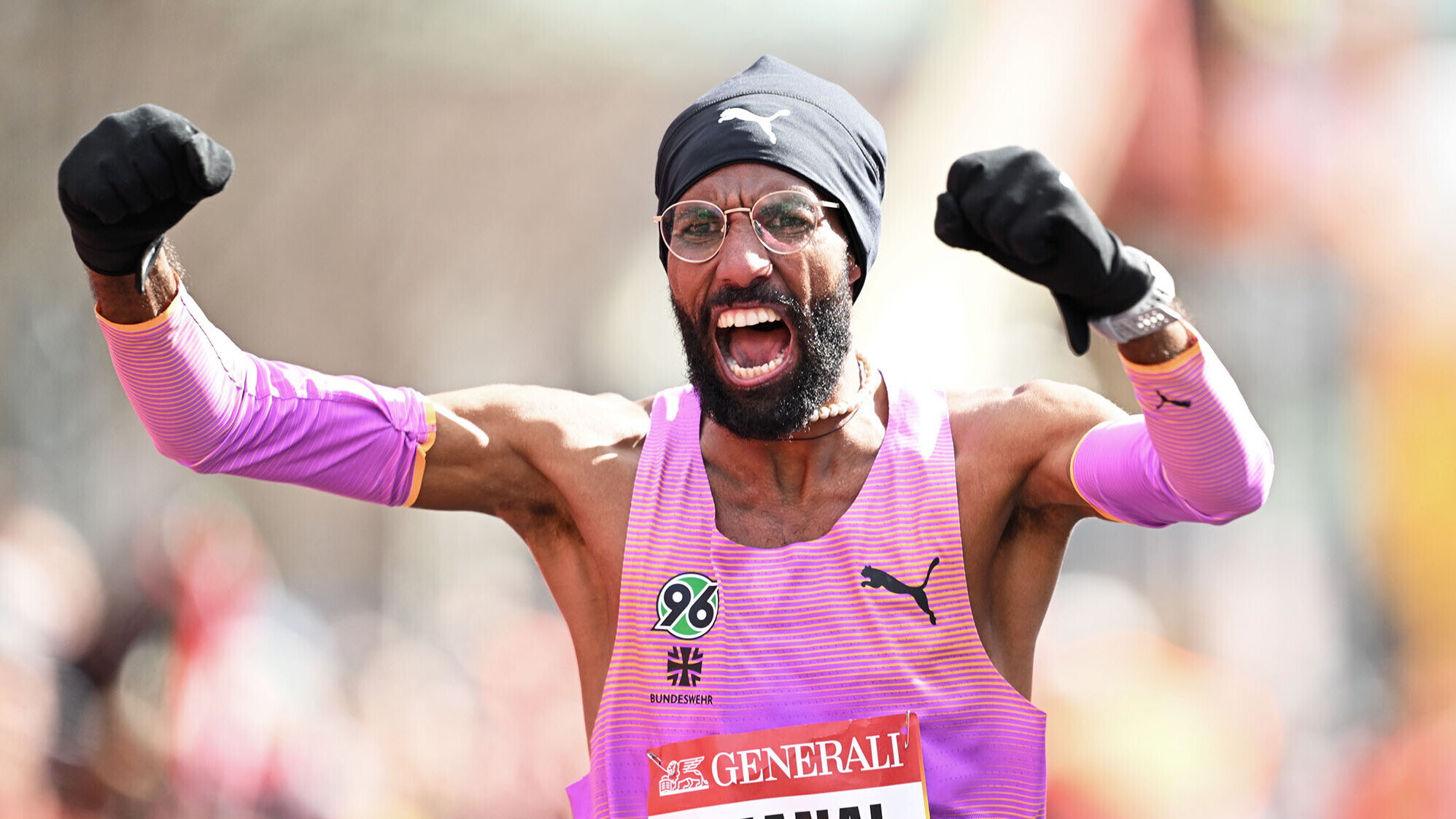 Amanal Petros jubelt im Trikot von Hannover 96 mit Stirnband und Handschuhen