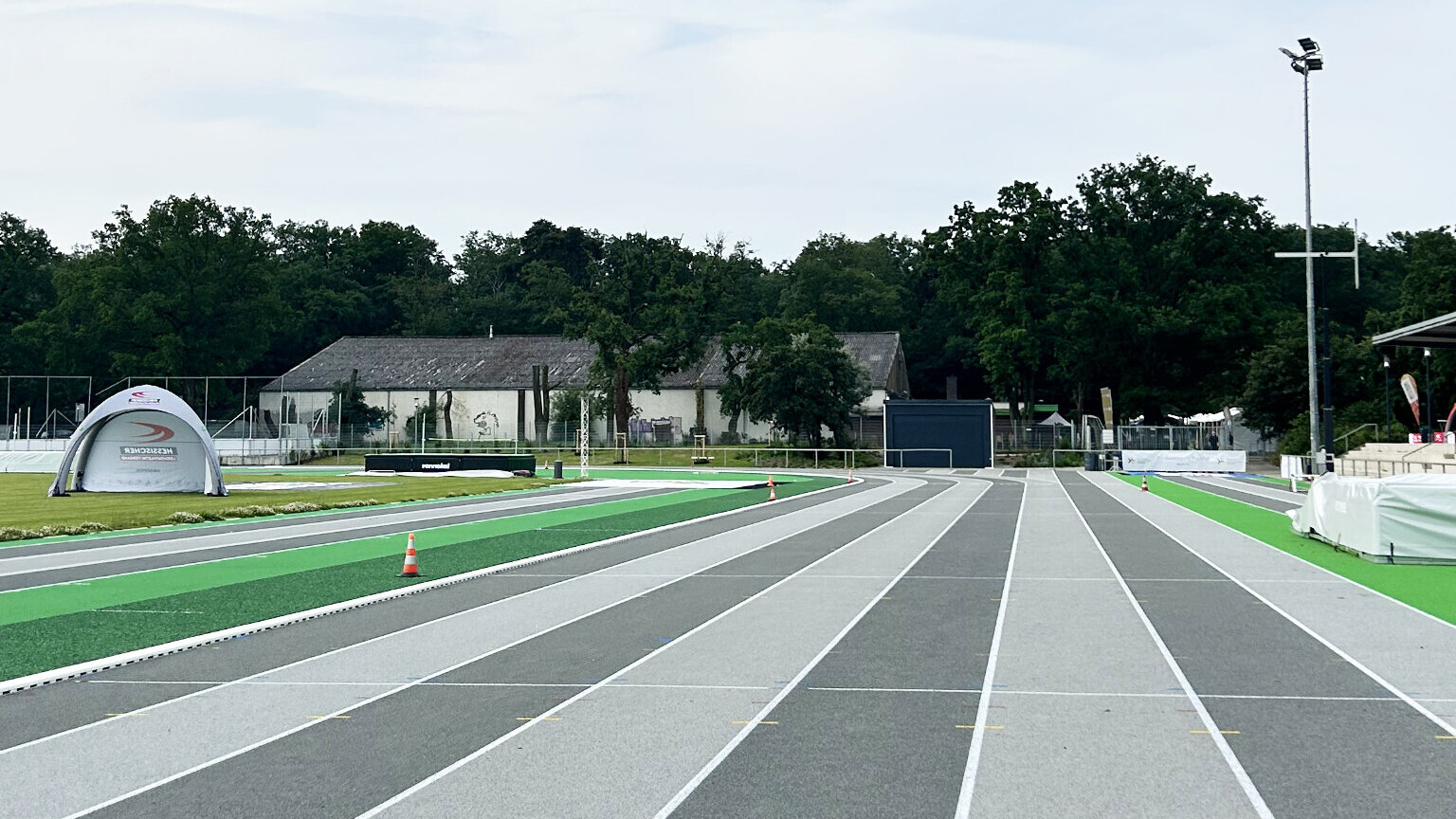 Panorama der neuen Leichtathletik-Anlage in Frankfurt am Main mit einer Kunststoffbahn in zwei verschiedenen Grautönen. 
