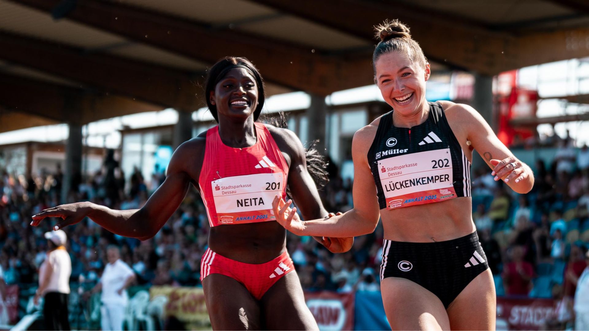Die Sprinterinnen Gina Lückenkemper und Daryll Neita lachend im Auslauf nach dem 100-Meter-Rennen. 